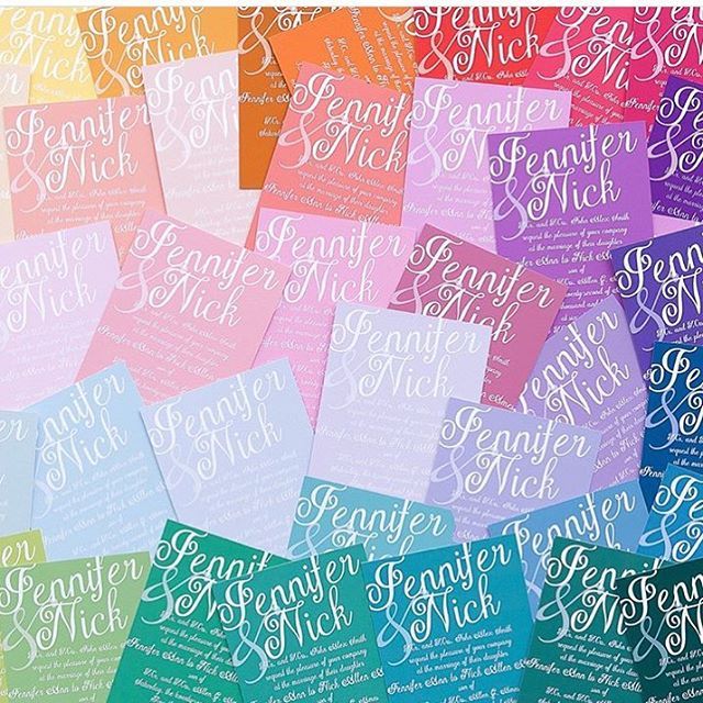 a colorful array of wedding invitations with white script lettering