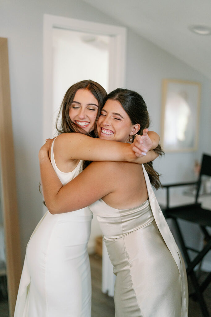 Bride and Maid of Honor hugging before first look