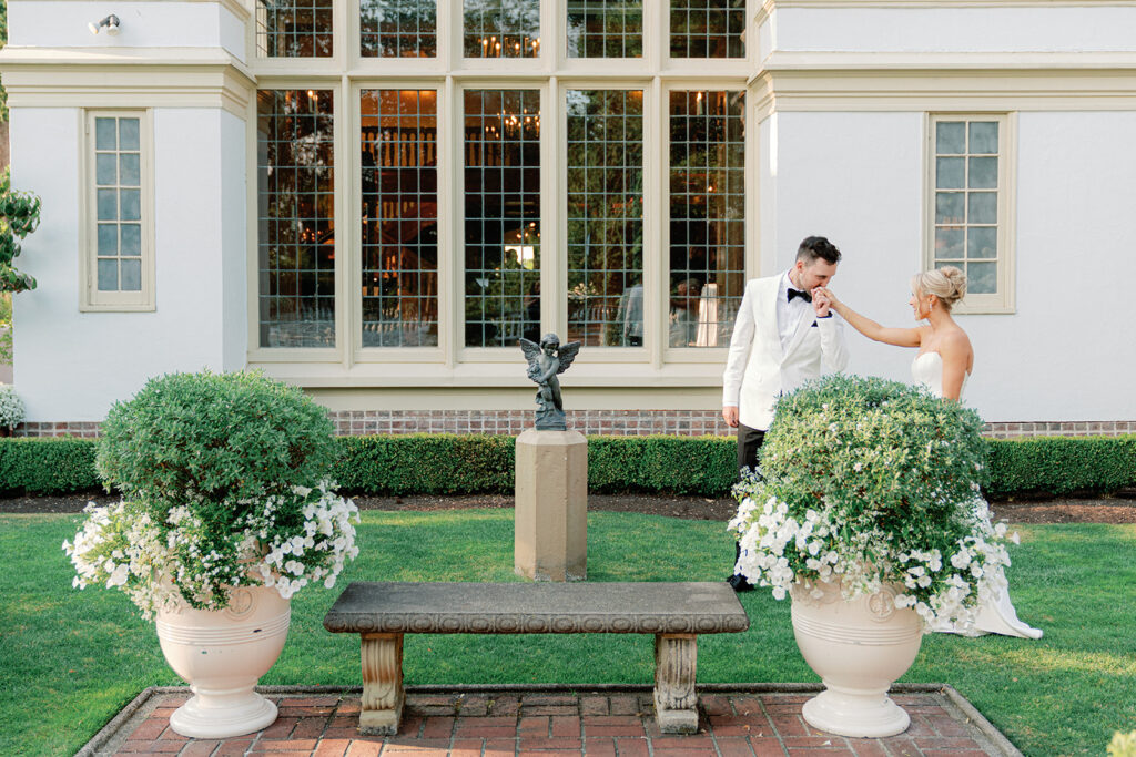Bride and groom sharing a romantic moment in front of the historic manor at Lairmont Manor, a stunning garden wedding venue in Washington.
