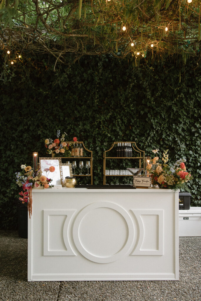 Elegant garden wedding bar display with florals and greenery at Twin Willow Gardens, a romantic garden wedding venue in Washington.