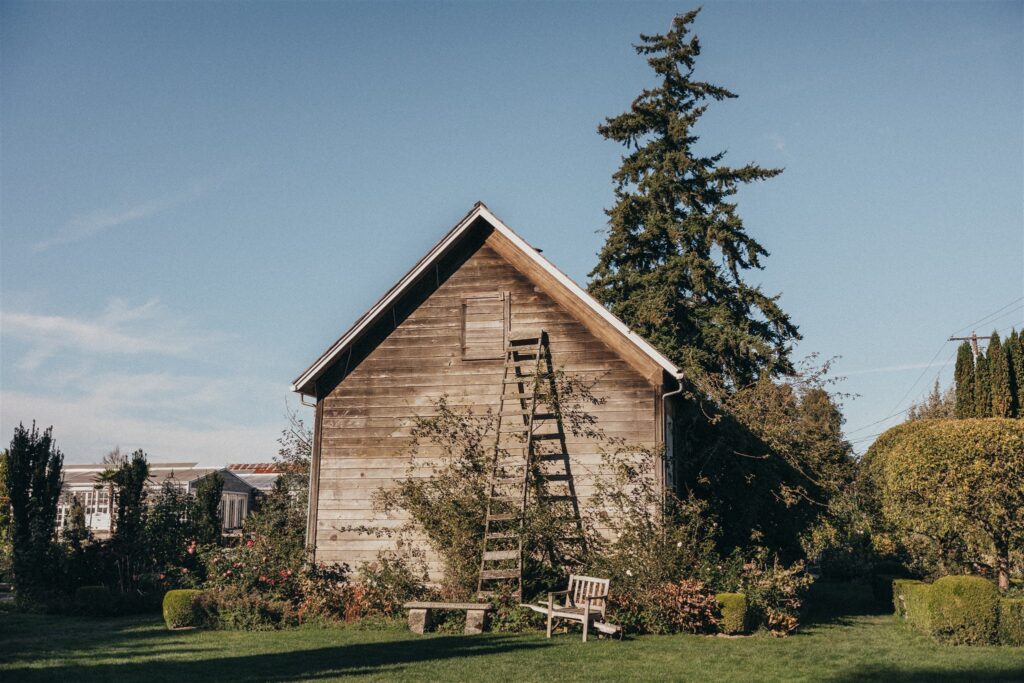 Backside of the Christianson's Nursery Schoolhouse surrounded by lush greenery, a charming example of garden wedding venues in Washington.